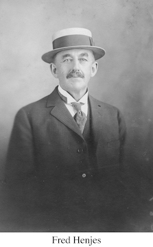 Fred Henjes wearing a coat, tie, and a brimmed hat